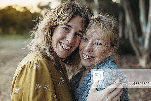 Close up portrait of adult mother and senior mother smiling outside