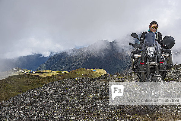 woman on touring motorbike at the pass of Abra de Malaga (4316 m)