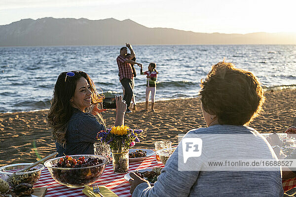 A family enjoys a beach picnic on the shoreline of Lake Tahoe  NV