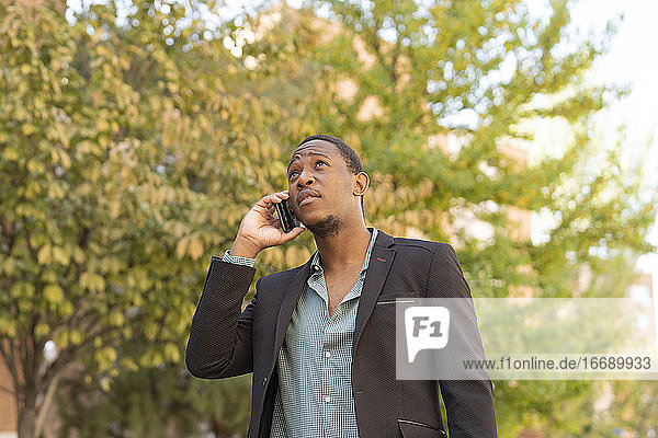 young stylish african man in the city talking from mobile phone