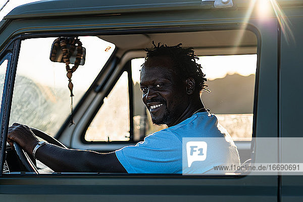 portrait of smiling afro american man driving