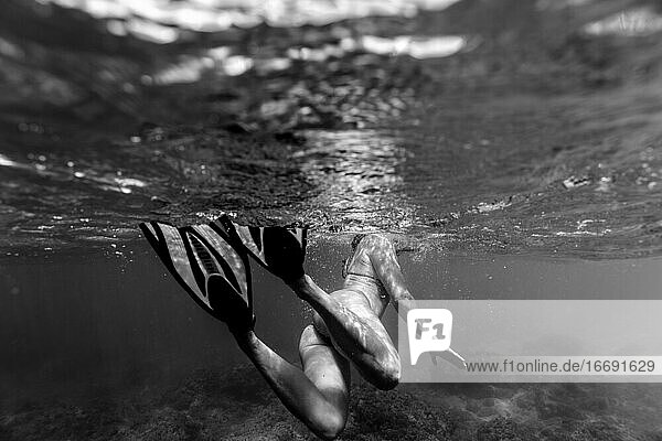 Schwarz-Weiß-Foto von weiblichen Schwimmen mit Flossen im Meer