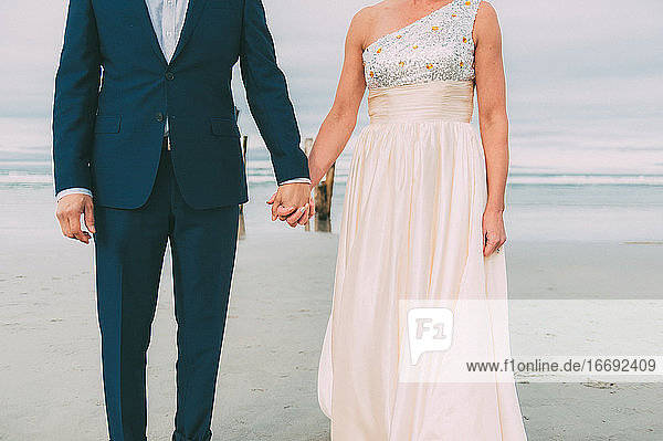 Newlyweds Holding Hands Beach Wedding