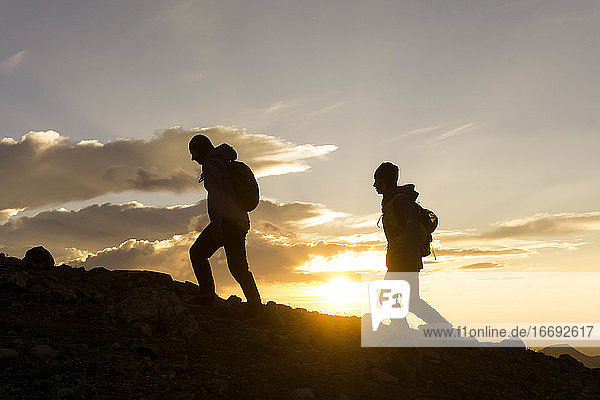 Silhouette weibliche Wanderer auf Berg gegen Himmel während Sonnenaufgang