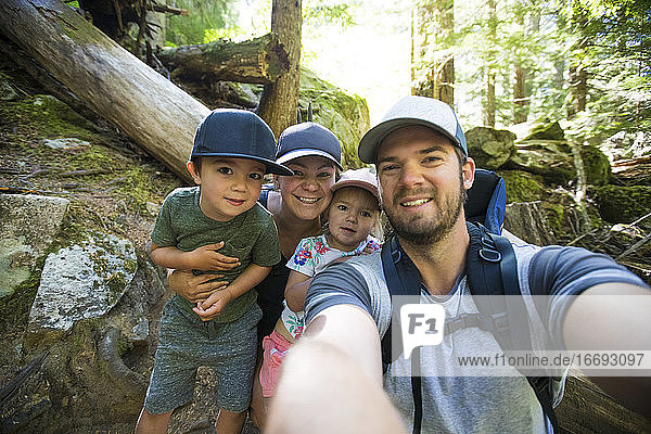 Family of four takes a selfie while hiking near Vancouver  Canada.