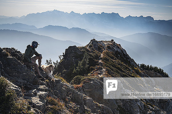 Wildfire Smoke In The North Cascades With Hiker and Dog on Summit