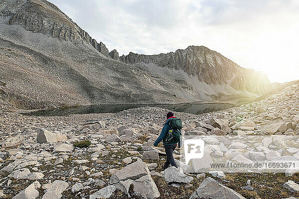 Woman walking amidst rocks on mountain
