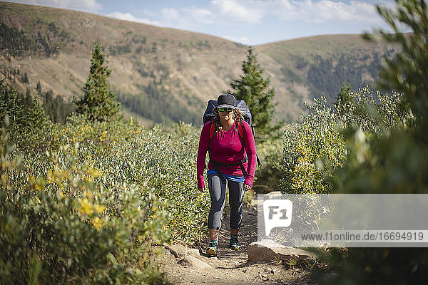 Woman hiking on mountain during summer