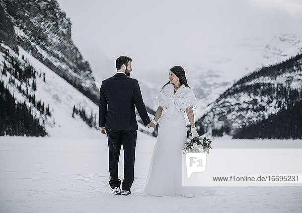 bride and groom wedding on ice in winter Lake Louise  Alberta  Canada