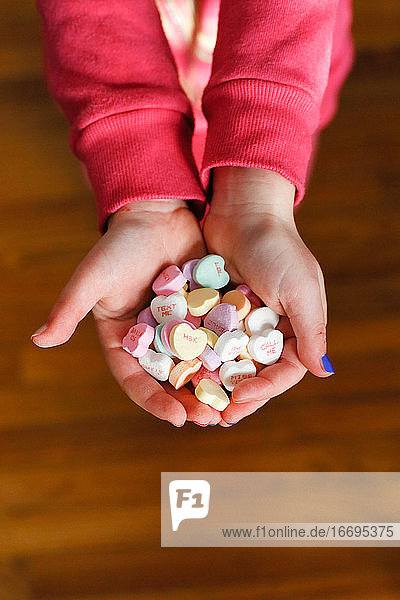 Child's Hands holding candy hearts on Valentine's Day