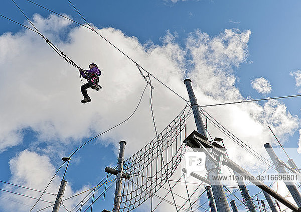 girl on a high swing at high rope access course in Iceland