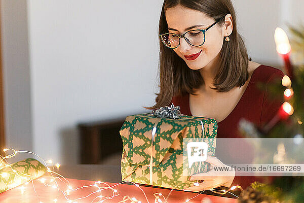 young millennial woman with christmas presents in a festive atmosphere