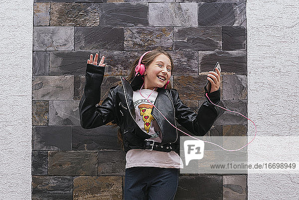 Beautiful girl feeling happy and listening music