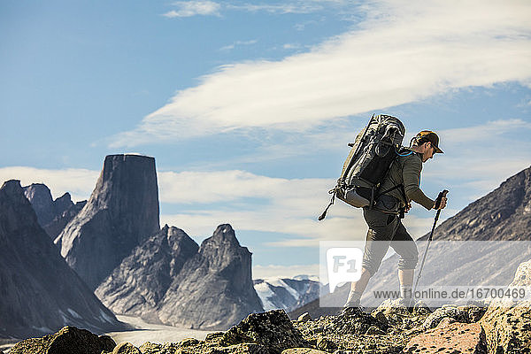 Backpacker on the move on rugged mountain ridge.