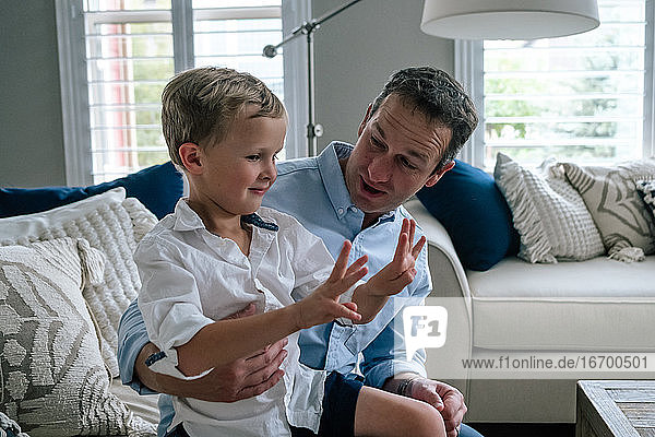 Young boy and dad using fingers to count