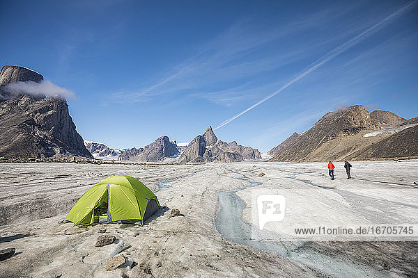 Two mountaineers explore the Caribou Glacier  Baffin Island  Canada.