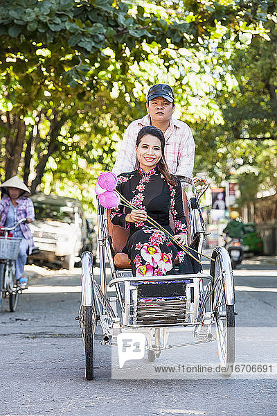 Woman sitting on a rickshaw in Hue / Vietnam