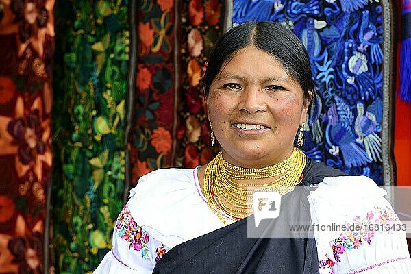 Indigenous vendor at the handicraft market  Plaza de los Ponchos  Otavalo  Imbabura province  Ecuador  South America