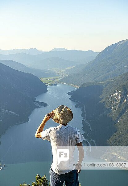Mountaineer  young man looking over mountain landscape  peak of the Bärenkopf  view of the Achensee  Karwendel  Tyrol  Austria  Europe