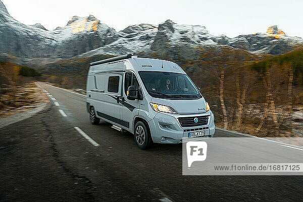 Campervan while driving on a road in front of a mountain near Nusfjord  Lofoten  Norway  Europe