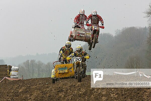 Motorcycle team in the air during a motocross race  Schnaitheim  Baden-Württemberg  Germany  Europe