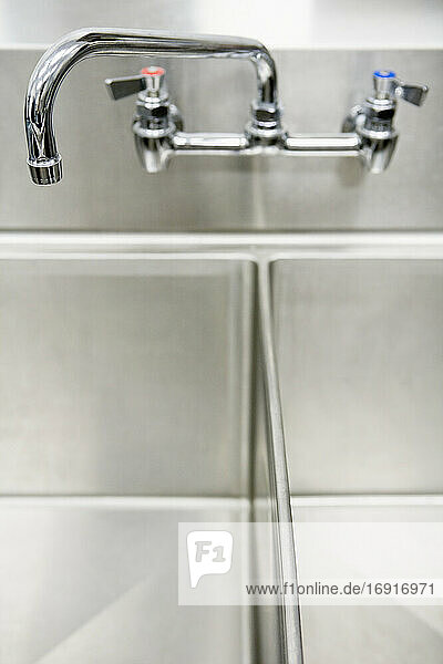 Tap over stainless steel metal double sink.
