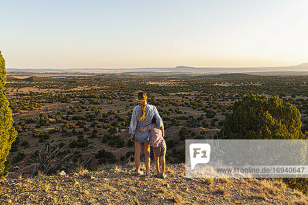 Teenage girl embracing her younger brother in the Galisteo Basin  Santa Fe