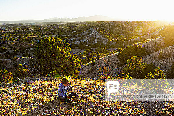 young boy in Galisteo Basin at sunset   Santa Fe