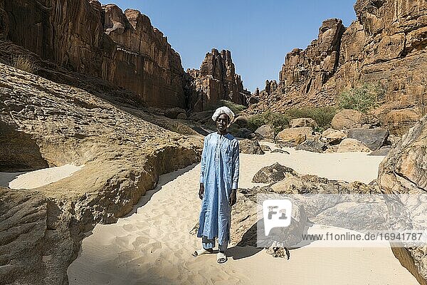 Young Beduin in traditional clothes at Guelta d'Archei waterhole  Ennedi plateau  Chad  Africa