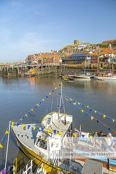 View of St. Mary's Church and restaurants  houses and boats on the River Esk  Whitby  Yorkshire  England  United Kingdom  Europe