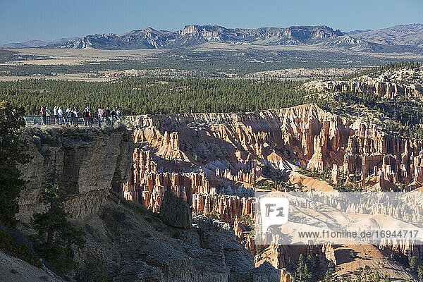 Visitors looking down into Bryce Amphitheatre from the Rim Trail at Bryce Point  Bryce Canyon National Park  Utah  United States of America  North America