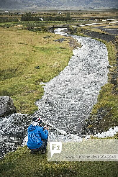 Tourist taking a photo at Gluggafoss (Window Falls aka Merkjarfoss)  a waterfall on the Merkja River  South Iceland (Sudurland)