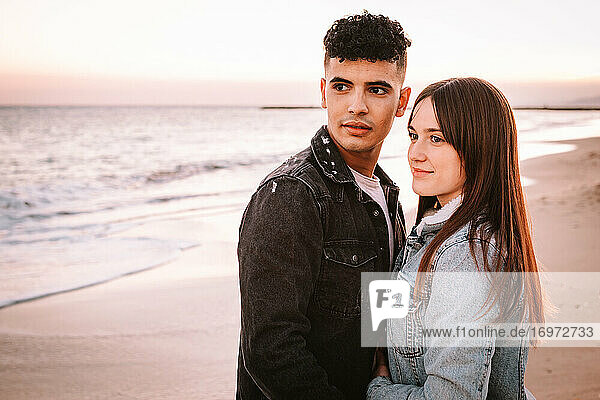 Shot Of A Young Couple In Love Posing On The Beach