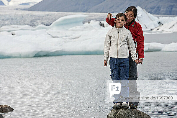 Mother and daughter exploring glacier lagoon in Iceland