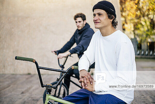 Two men posing with their bmx bikes in the city of Madrid Spain