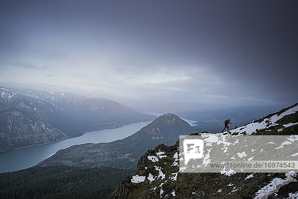 A young man climbs on Dog Mountain overlooking the Columbia Gorge.
