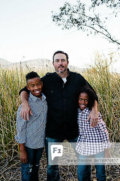 Vater posiert mit Söhnen im Park in Chula Vista