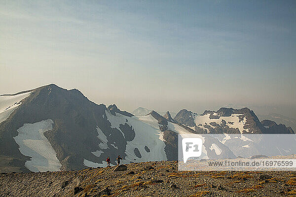 Two hikers climb to the top of Glacier Peak in Washington.