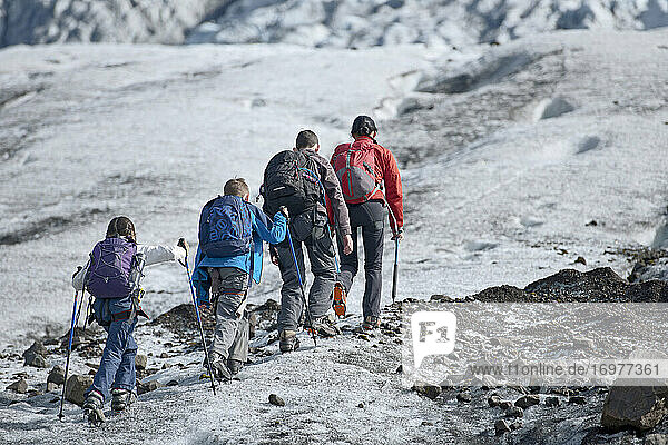 Family exploring the edges of Vatnajokull glacier in Iceland