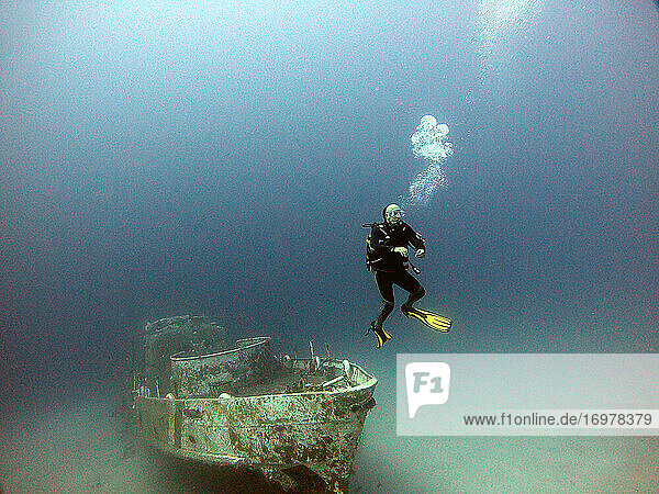 A diver dives next to the wreck.Antalya Kas Turkey