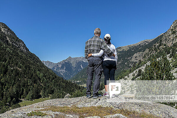 Middle aged tourist couple looking forward to landscape  Mountain Pyrenees of Spain
