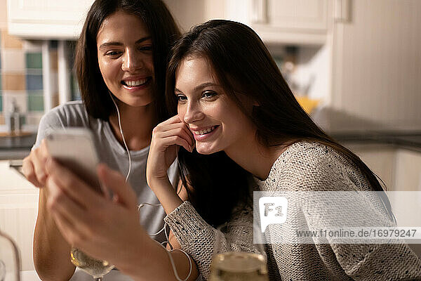 Happy woman sharing playlist with friend