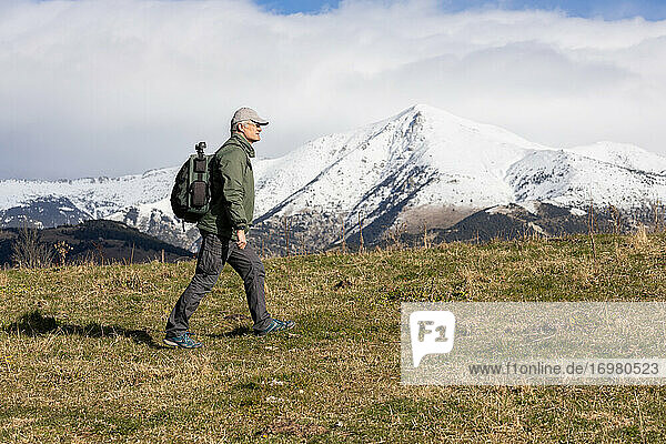 Middle aged caucasian tourist man walking on the Spanish Pyrenees