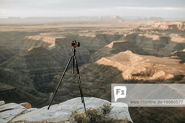 camera and tripod on cliff edge in front of scenic view  Utah desert