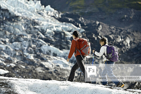 Mother and daughter hiking on Vatnajokull glacier in Iceland
