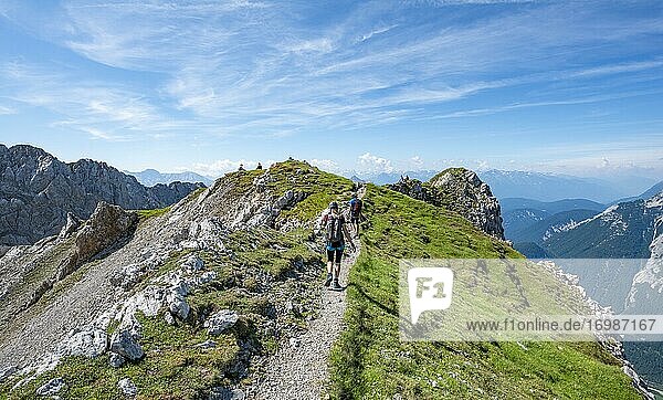 Mountaineers hiking on a ridge  fixed rope route Mittenwalder Höhenweg  Karwendel Mountains  Mittenwald  Bavaria  Germany  Europe