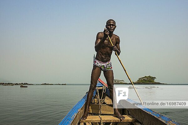 Man pushing his small boat on Banana islands  Sierra Leone  Africa