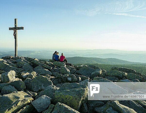 Summit cross and mountain hiker on the Lusen  Bavarian Forest National Park  Bavaria  Germany  Europe