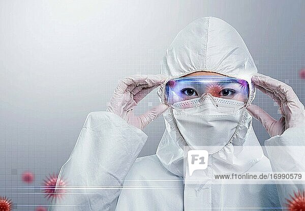Junge Ärztin trägt Schutzkleidung