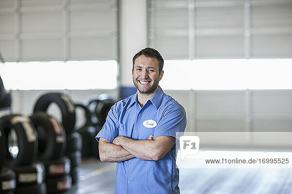 Portrait of a smiling Caucasian male mechanic in an auto repair shop